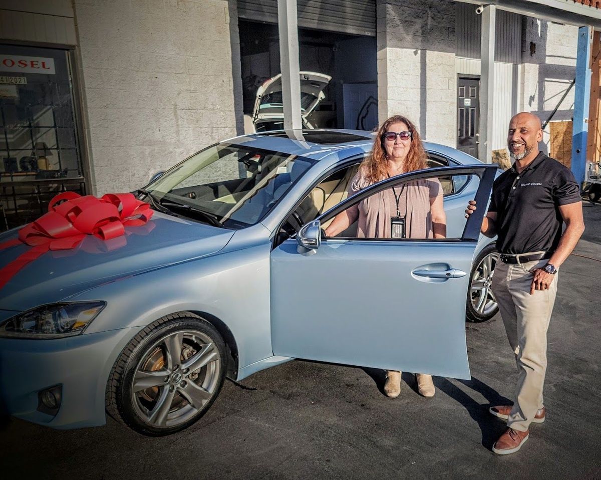 Iconic Coach customers with their new car