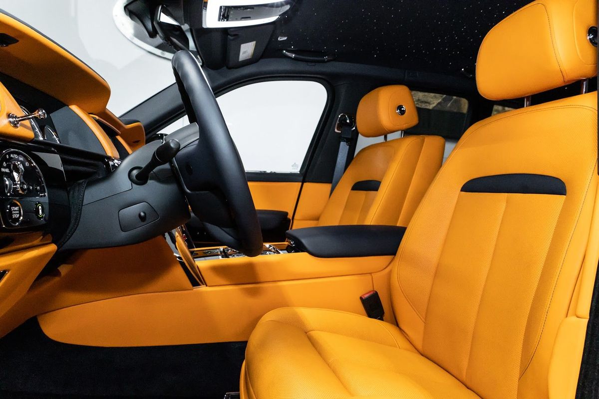 A vehicle interior with orange leather